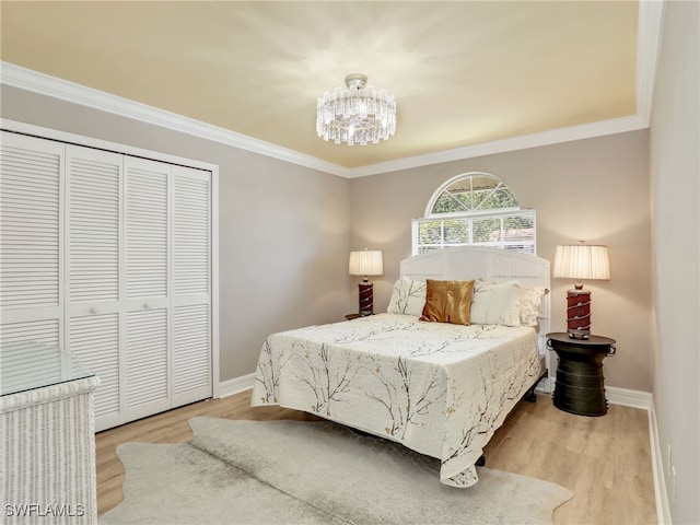 11526 Forest Mere Dr, Bonita Springs, FL 34135 - bedroom with a closet, wood finished floors, a chandelier, and baseboards
