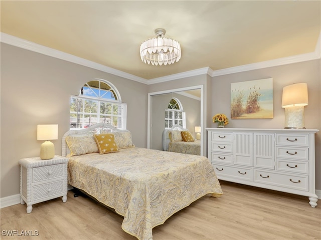 11526 Forest Mere Dr, Bonita Springs, FL 34135 - bedroom featuring a notable chandelier, a closet, baseboards, ornamental molding, and light wood-style floors