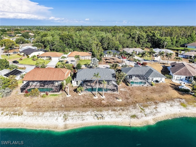 11526 Forest Mere Dr, Bonita Springs, FL 34135 - birds eye view of property featuring a water view, a residential view, a wooded view, and a view of the beach