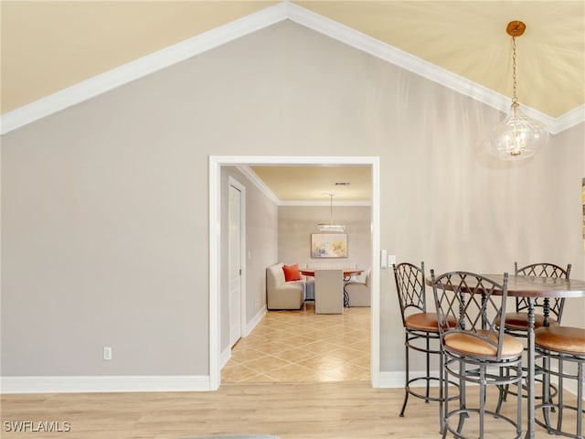 11526 Forest Mere Dr, Bonita Springs, FL 34135 - dining room with lofted ceiling, a notable chandelier, baseboards, ornamental molding, and light wood-style floors