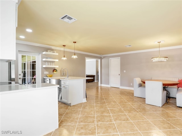 11526 Forest Mere Dr, Bonita Springs, FL 34135 - kitchen featuring a sink, open floor plan, visible vents, light countertops, and ornamental molding
