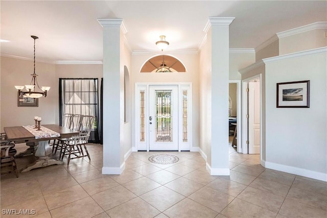 foyer featuring light tile patterned floors, baseboards, ornamental molding, and a notable chandelier
