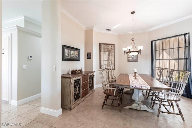 dining area with baseboards, ornamental molding, visible vents, and a chandelier