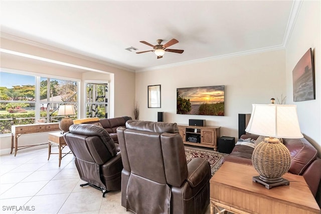 living area with ceiling fan, visible vents, crown molding, light tile patterned floors, and baseboards
