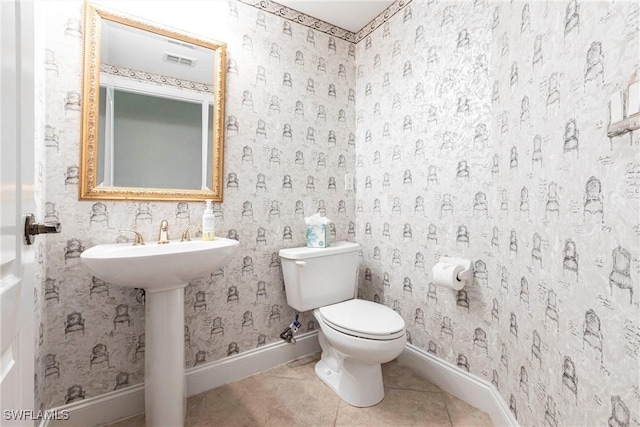 bathroom with baseboards, tile patterned flooring, toilet, and visible vents