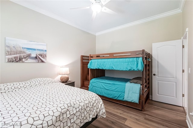 bedroom featuring a ceiling fan, ornamental molding, and wood finished floors