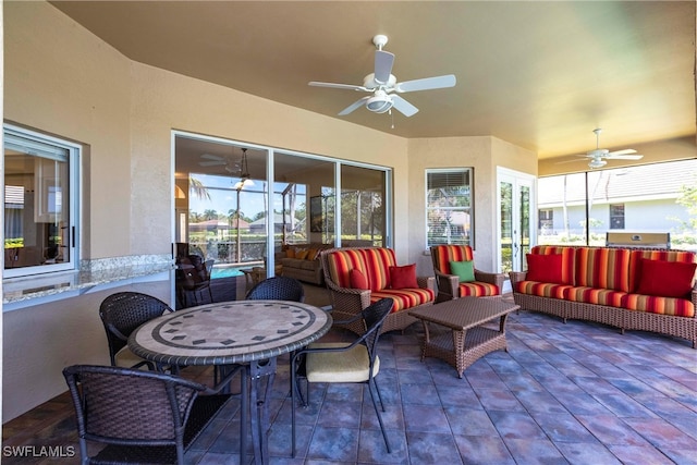 view of patio / terrace featuring an outdoor living space, a ceiling fan, and grilling area