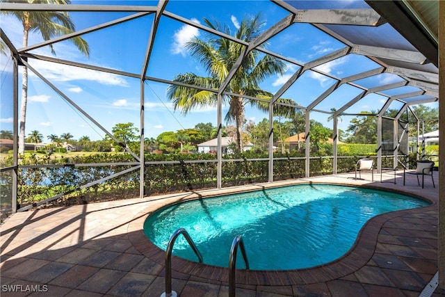 outdoor pool with a patio area and a lanai