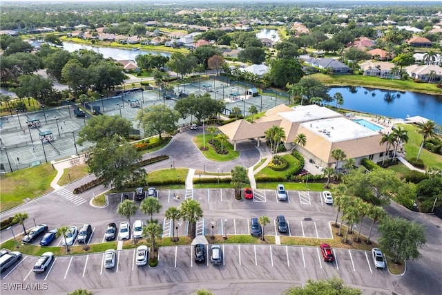 drone / aerial view featuring a water view and a residential view