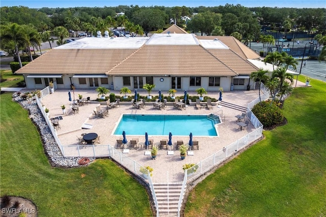 view of pool featuring fence and a yard