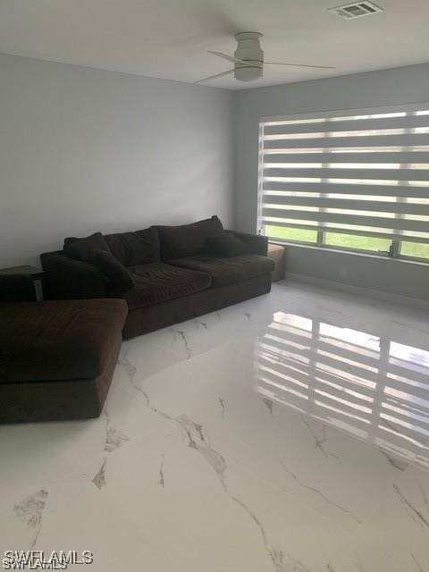 living area with marble finish flooring and ceiling fan