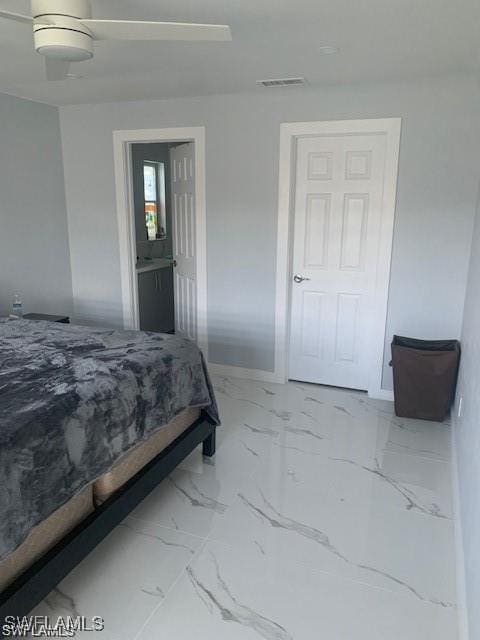 bedroom with marble finish floors and baseboards