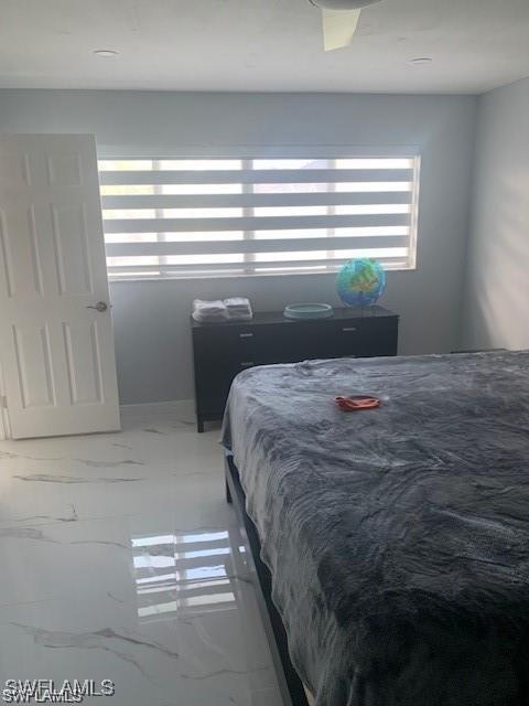 bedroom featuring marble look tiles