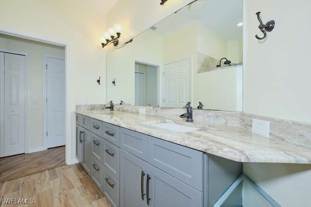 14571 Grande Cay Cir Unit 3203, Fort Myers, FL 33908 - bathroom with double vanity, a sink, and wood finished floors