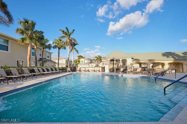 14571 Grande Cay Cir Unit 3203, Fort Myers, FL 33908 - community pool featuring a patio and fence