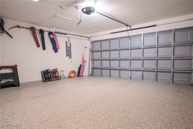 garage featuring electric panel and a garage door opener