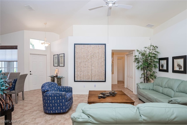living area featuring high vaulted ceiling, light tile patterned floors, a ceiling fan, and visible vents