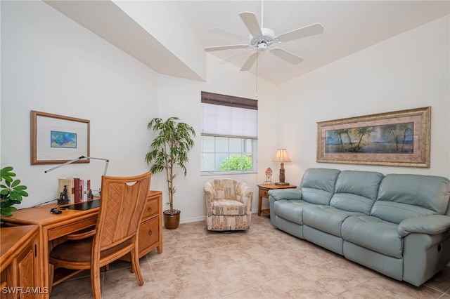 living area featuring lofted ceiling, baseboards, light tile patterned floors, and a ceiling fan