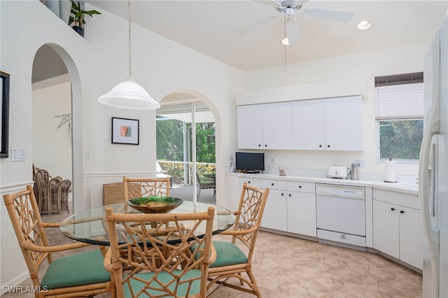 kitchen featuring white cabinetry, a ceiling fan, arched walkways, and white appliances