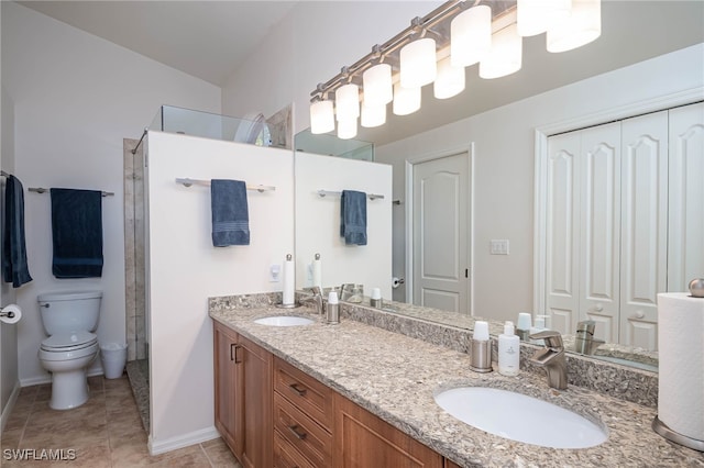 full bath with walk in shower, toilet, baseboards, and a sink