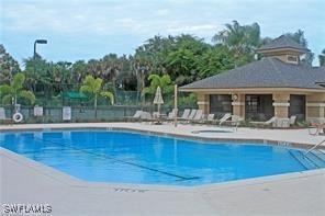 pool featuring fence and a patio