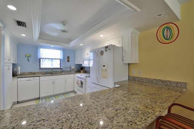 25402 Golf Lake Cir Unit 114, Bonita Springs, FL 34135 - kitchen with crown molding, white cabinets, white appliances, and light stone countertops
