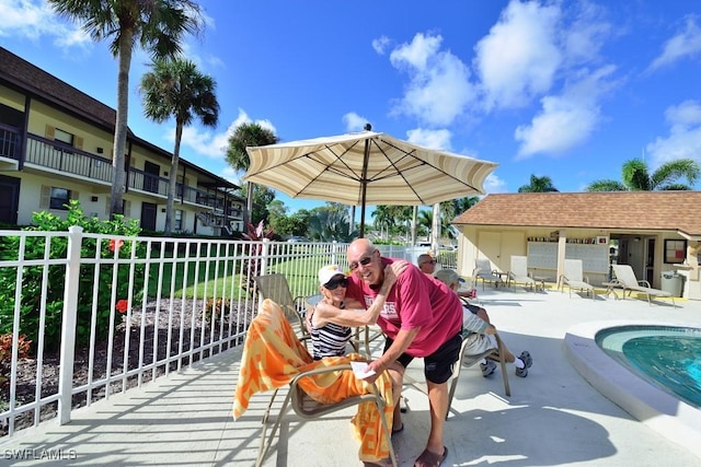 25402 Golf Lake Cir Unit 114, Bonita Springs, FL 34135 - exterior space with a swimming pool, fence, and a patio