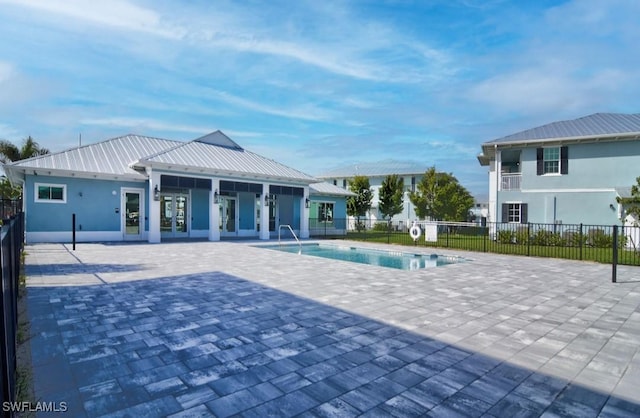 community pool featuring a patio area and fence