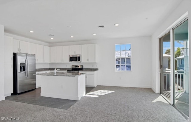 kitchen featuring dark colored carpet, white cabinetry, visible vents, and stainless steel appliances