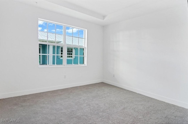 unfurnished room with baseboards and carpet