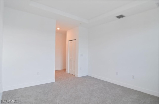carpeted spare room with recessed lighting, baseboards, and visible vents