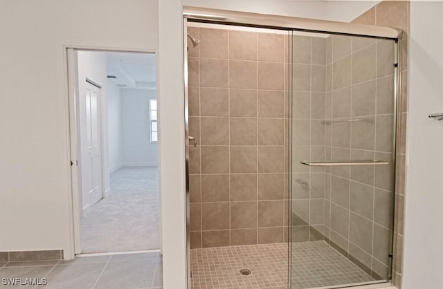 bathroom with tile patterned floors and a shower stall