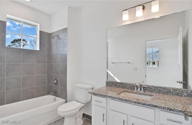 bathroom featuring tile patterned flooring, vanity, bathtub / shower combination, toilet, and baseboards