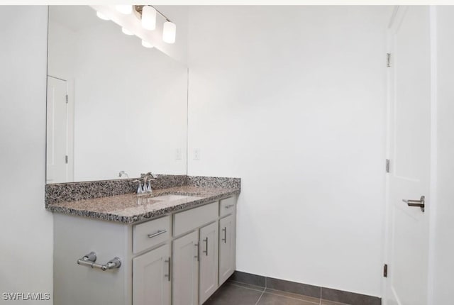 bathroom with tile patterned floors, baseboards, and vanity