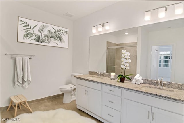 full bath with a sink, tile patterned flooring, a shower stall, and toilet