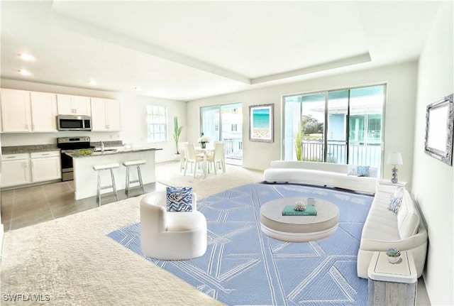 26381 Coco Cay Cir SW Unit 203, Bonita Springs, FL 34135 - living room featuring recessed lighting and a tray ceiling