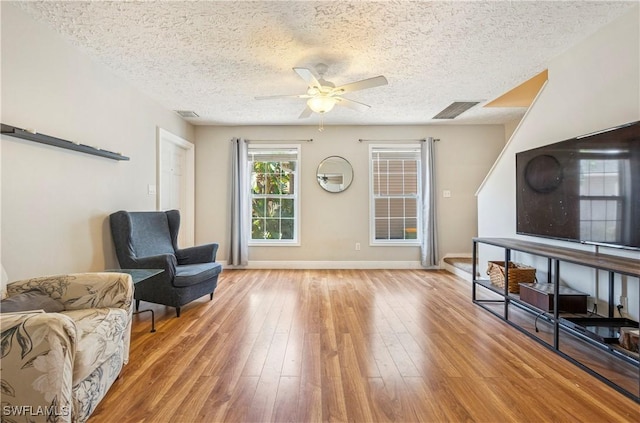 239 Leawood Cir, Naples, FL 34104 - sitting room featuring a ceiling fan, a textured ceiling, light wood-style flooring, and baseboards