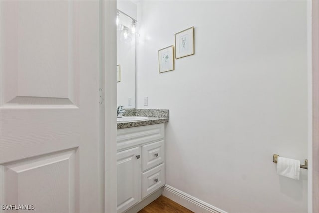 239 Leawood Cir, Naples, FL 34104 - bathroom featuring vanity, wood finished floors, and baseboards