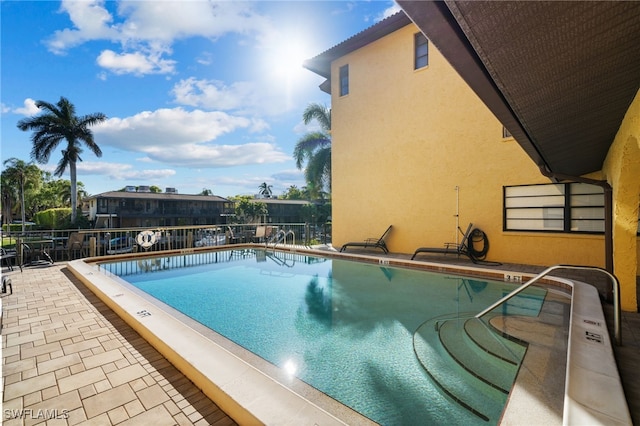 1400 Blue Point Ave Unit 202, Naples, FL 34102 - community pool featuring a patio and fence