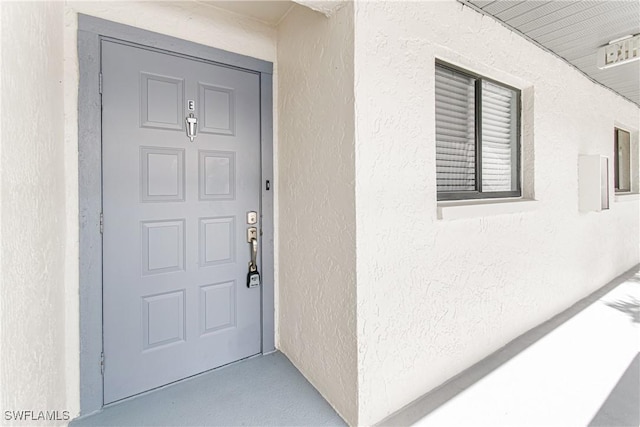 6308 Sugar Bush Ln Unit E, Fort Myers, FL 33908 - doorway to property featuring stucco siding