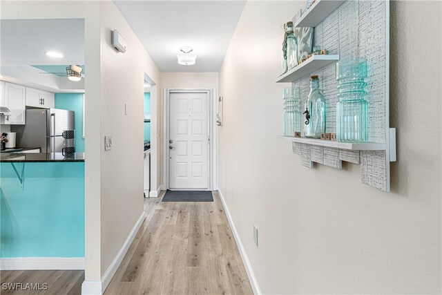 6308 Sugar Bush Ln Unit E, Fort Myers, FL 33908 - doorway to outside featuring light wood-type flooring, baseboards, and a ceiling fan
