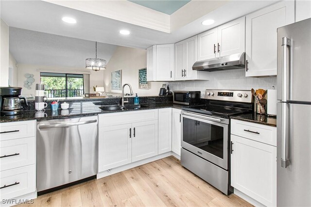6308 Sugar Bush Ln Unit E, Fort Myers, FL 33908 - kitchen featuring under cabinet range hood, stainless steel appliances, a sink, white cabinetry, and recessed lighting