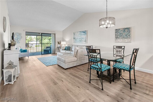 6308 Sugar Bush Ln Unit E, Fort Myers, FL 33908 - dining area with a chandelier, light wood finished floors, lofted ceiling, and baseboards