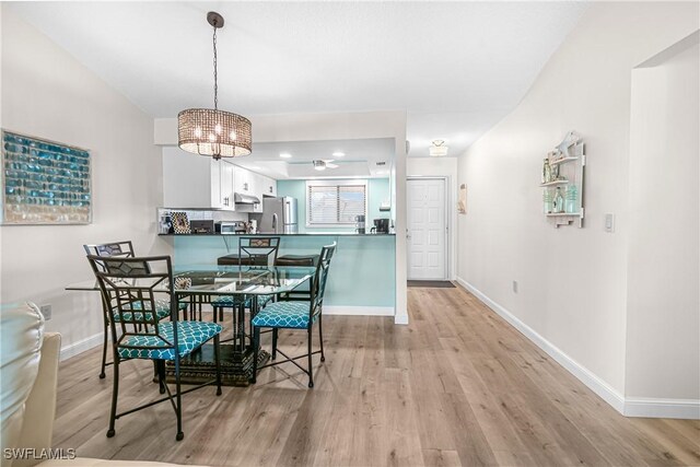 6308 Sugar Bush Ln Unit E, Fort Myers, FL 33908 - dining space with light wood-style flooring, baseboards, and a chandelier