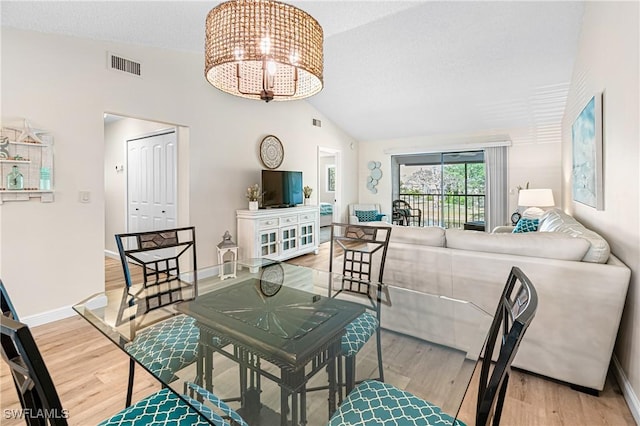 6308 Sugar Bush Ln Unit E, Fort Myers, FL 33908 - dining area featuring wood finished floors, lofted ceiling, a chandelier, and baseboards