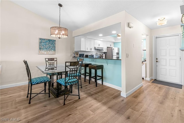 6308 Sugar Bush Ln Unit E, Fort Myers, FL 33908 - dining area featuring baseboards, a chandelier, light wood finished floors, and recessed lighting