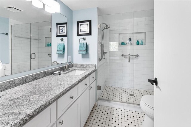 6308 Sugar Bush Ln Unit E, Fort Myers, FL 33908 - bathroom with toilet, a stall shower, vanity, and tile patterned floors