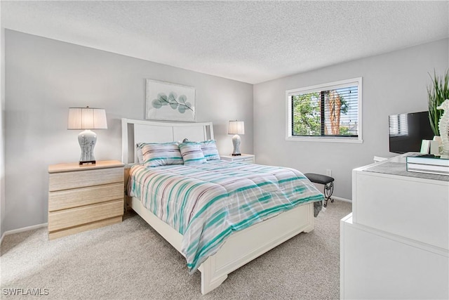 6308 Sugar Bush Ln Unit E, Fort Myers, FL 33908 - bedroom featuring light colored carpet, a textured ceiling, and baseboards