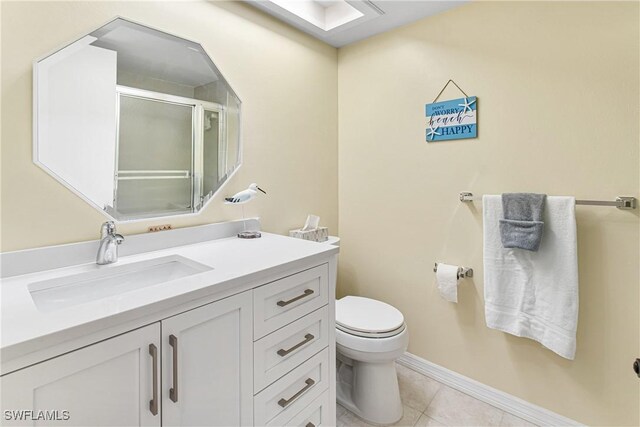 6308 Sugar Bush Ln Unit E, Fort Myers, FL 33908 - full bath with a stall shower, toilet, vanity, tile patterned flooring, and baseboards