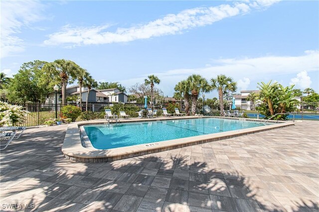6308 Sugar Bush Ln Unit E, Fort Myers, FL 33908 - community pool with fence and a patio area